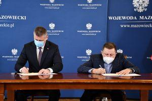 Zdjęcie: dwóch mężczyzn (Burmistrz Mszczonowa i Wicewojewoda) podpisujący umowę